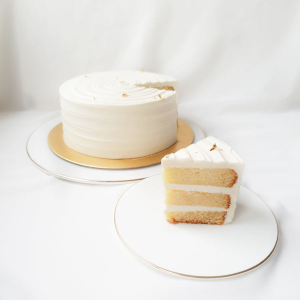 Soft vanilla sponge frosted with silky vanilla bean buttercream and topped with a gentle touch of gold leaves. 