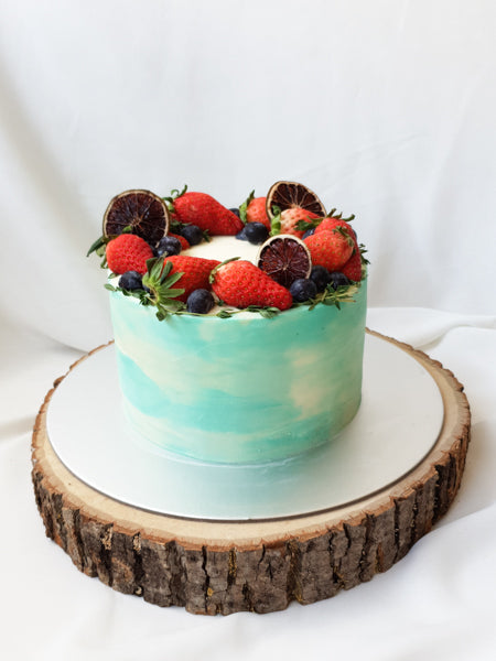 Refreshing mixed berries on top of a watercolour cake